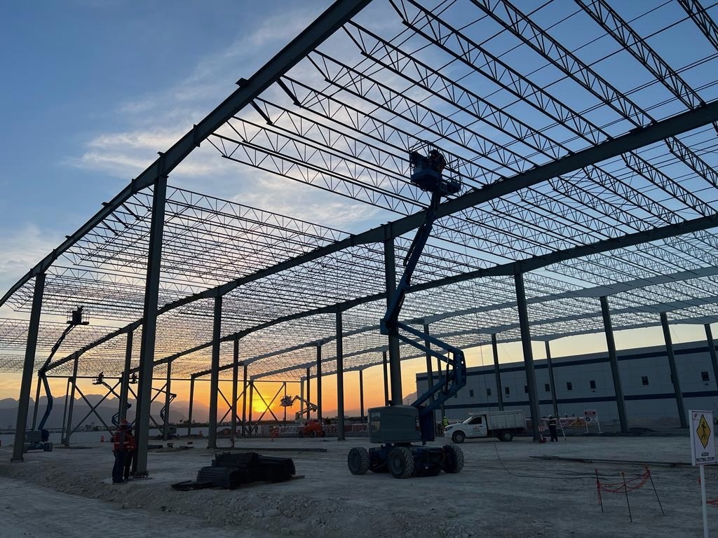 Steel structure erection on site at dusk